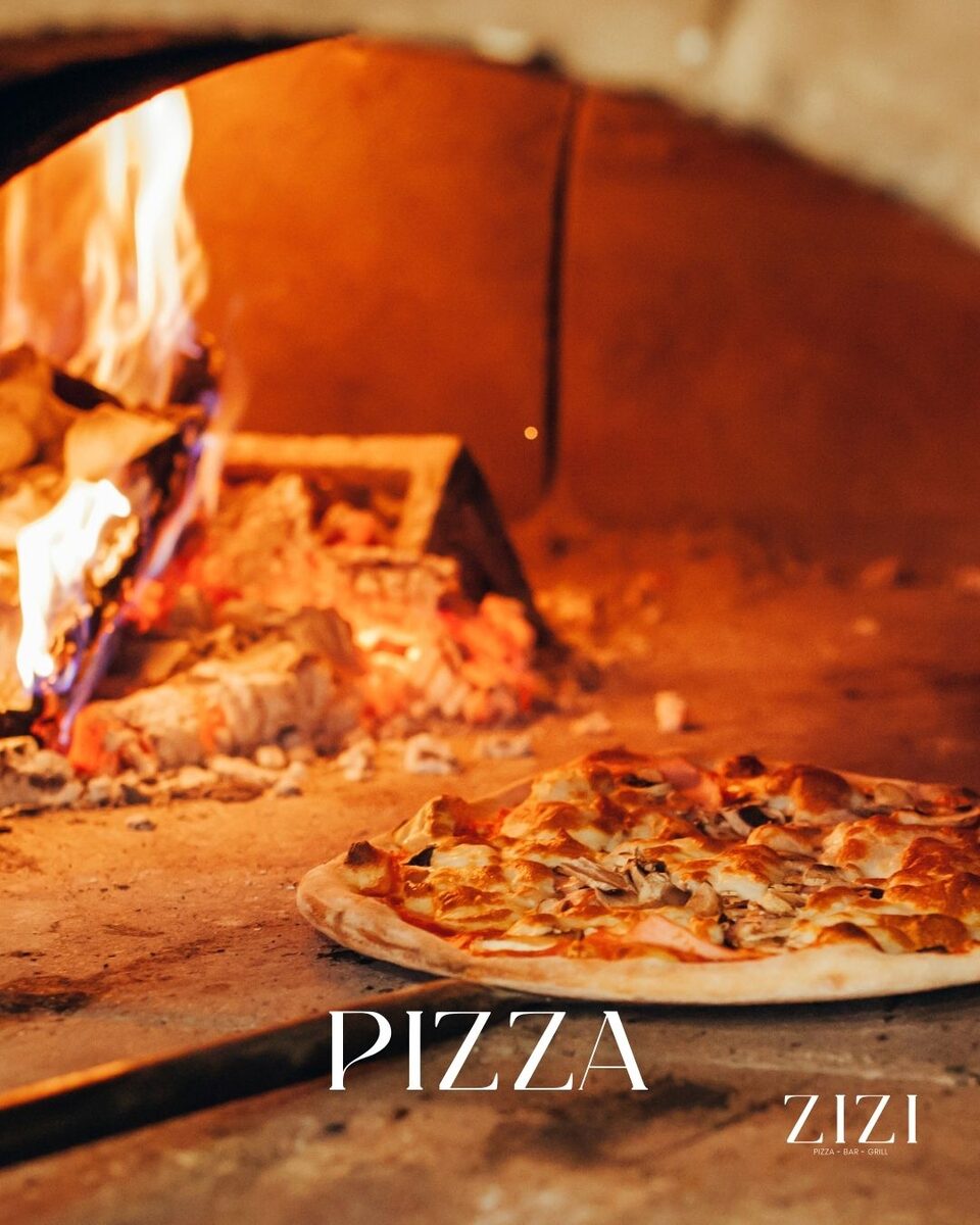Wood-fired oven baking a sourdough pizza at Zizi's Restaurant, Umtentweni, KZN South Coast